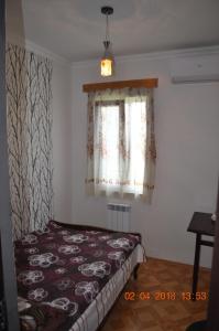 a bedroom with a bed and a window at Hotel Kharabadze in Kutaisi