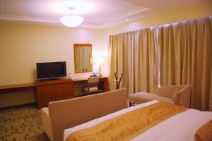 Voodi või voodid majutusasutuse Jian Guo Garden Hotel toas