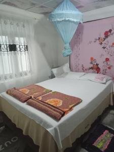 a bedroom with a bed with a blanket on it at Damsen Homestay Ella in Ella +32 photos