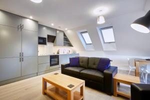 a living room with a couch and a table at Imperial Court By Viridian Apartments in Maidenhead