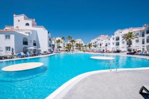 a swimming pool in the middle of a resort at FERGUS Style Carema Beach in Cala en Bosc