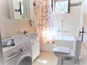 a bathroom with a washing machine and a sink at Menina Farm Kalamata Countryside in Perivolákia