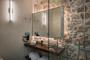 a bathroom with a shower and a sink with a mirror at Ambassadors Residence Boutique Hotel in Chania