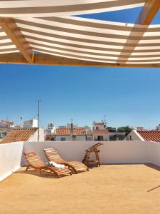two chairs sitting on top of a roof at Alvor Terrace Villa in Alvor