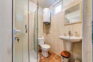 a bathroom with a toilet and a sink and a shower at Black Sea Pearl in Varna City