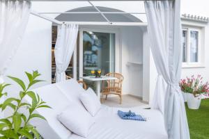a living room with a white couch and a table at FERGUS Style Carema Beach in Cala en Bosc