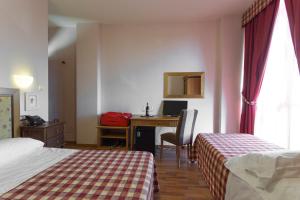 Posteľ alebo postele v izbe v ubytovaní Hotel Il Giardino