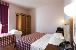 Posteľ alebo postele v izbe v ubytovaní Hotel Il Giardino