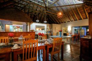 a dining room with a table and chairs in a room at De Old Drift Guest Farm in Addo