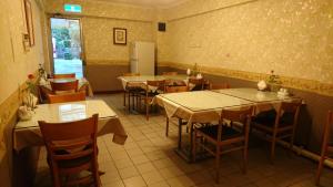 a restaurant with tables and chairs in a room at Park Motel in Chiayi City