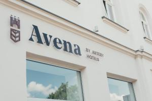 a sign on the side of a building at Avena Boutique Hotel by Artery Hotels in Krakow