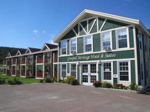a large building with green and white at Grenfell Heritage Hotel & Suites in St. Anthony