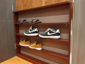 a shelf with three pairs of shoes on it at Stay Amare Green La Salle Taft in Manila