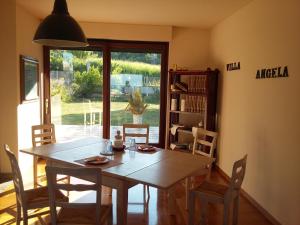 a dining room with a wooden table and chairs at Villa Angela in San Benedetto del Tronto +42 photos