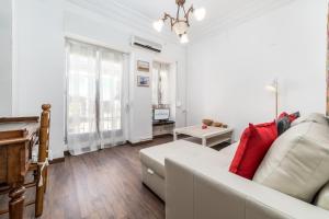 a living room with a white couch and a table at Travel Habitat Cabanyal in Valencia