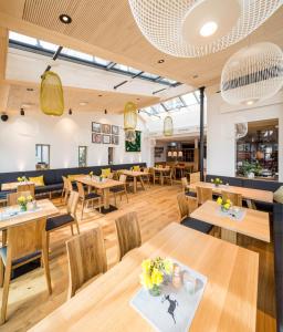 a dining room with wooden tables and chairs at Hotel Waldhorn in Kempten