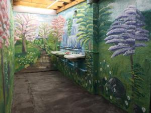 a bathroom with a painting on the wall at Arista Yurt Camp in Karakol