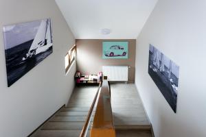 a staircase in a house with pictures on the walls at Csöpi Panzió in Tihany