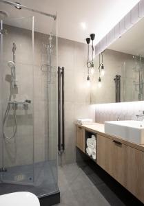 a bathroom with a shower and a sink at VIU Old Town Terrace in Gdańsk