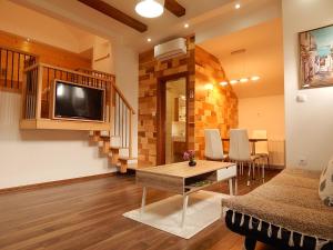 Televízia a/alebo spoločenská miestnosť v ubytovaní Studio apartman Lakasa