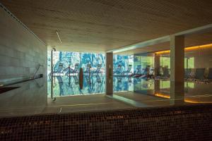 a room with a large window with chairs in it at Hotel Steffisalp - Ski-in & Ski-out am Arlberg in Warth am Arlberg