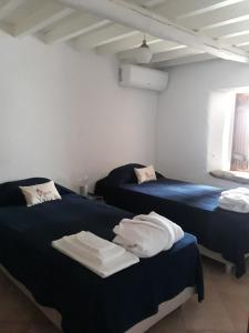 A bed or beds in a room at Casinha de Marvao