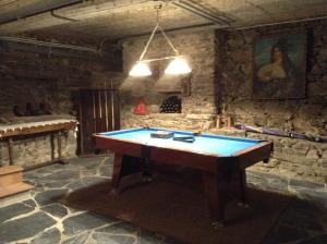 a pool table in a room with a stone wall at Casa Portela in Portela de Portomourisco