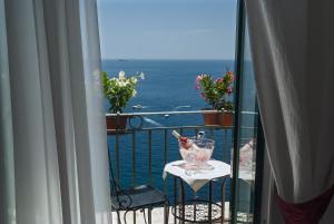 a view of the ocean from a balcony with a table at Hotel Montemare in Positano