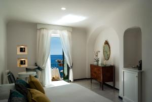 a bedroom with a bed and a view of the ocean at Hotel Montemare in Positano