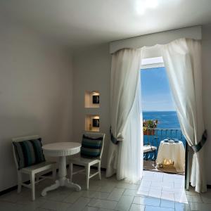 a dining room with a table and a view of the ocean at Hotel Montemare in Positano