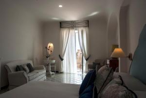 a living room with a couch and a window at Hotel Montemare in Positano