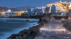a view of a city at night at Asteria Hotel in Naxos Chora