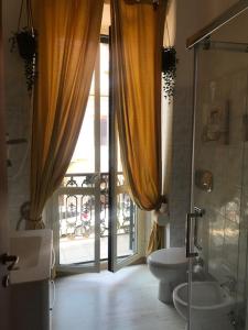 a bathroom with a toilet and a glass door at Appartamenti Antica Salaria in San Benedetto del Tronto
