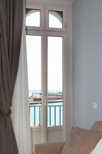 a bedroom with a window with a view of the ocean at Dimora Marinucci in Termoli