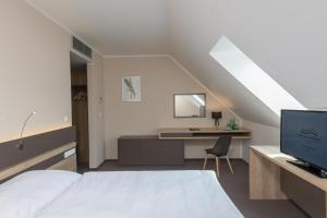 Posteľ alebo postele v izbe v ubytovaní Hotel Panská Zahrada