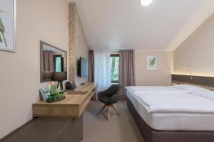 Posteľ alebo postele v izbe v ubytovaní Hotel Panská Zahrada