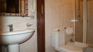 a bathroom with a sink, toilet and shower at Hotel Gresi in Catania