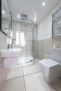 a bathroom with a toilet and a sink and a shower at Grosvenor Suites in Edinburgh