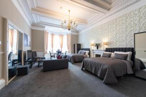 a bedroom with two beds and a living room at Grosvenor Suites in Edinburgh