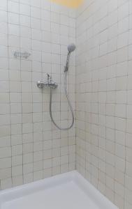 a shower in a tiled bathroom with a shower head at Island of love in Turanj