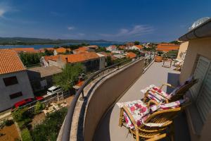 a balcony with chairs and a view of a city at Island of love in Turanj