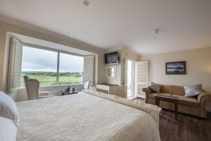 a bedroom with a large bed and a large window at Sea Breeze Lodge B&B in Galway