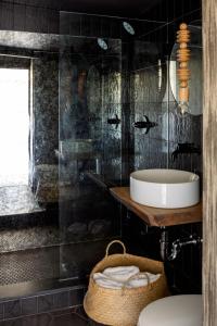 a bathroom with a sink and a tub at AWOL Hotel Provincetown in Provincetown