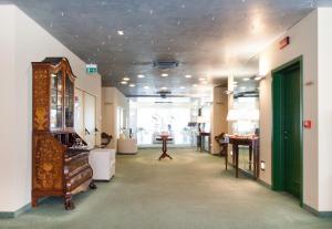 a room with a hallway with a room with a dresser at Hotel Senator in Gorgonzola