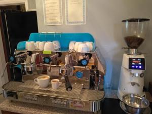 a coffee making machine with cups on a counter at Shandon Bells Guest House in Cork