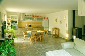 a kitchen and dining room with a table and chairs at La Rousse in Roussillon