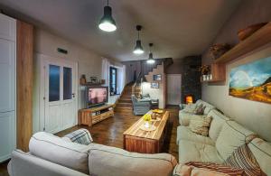 a living room with two couches and a tv at Sad nad Klingerom in Banská Štiavnica