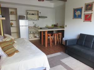a living room with a couch and a kitchen at Cabañas Donde La Oma in Villarrica +18 photos