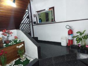 a bathroom with a bath tub with flowers and a fire hydrant at Hotel Flor da Vila Mariana in Sao Paulo