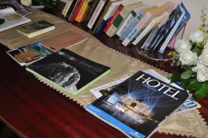 a table with books and magazines on it at Hotel Parsifal - Antico Convento del 1288 in Ravello